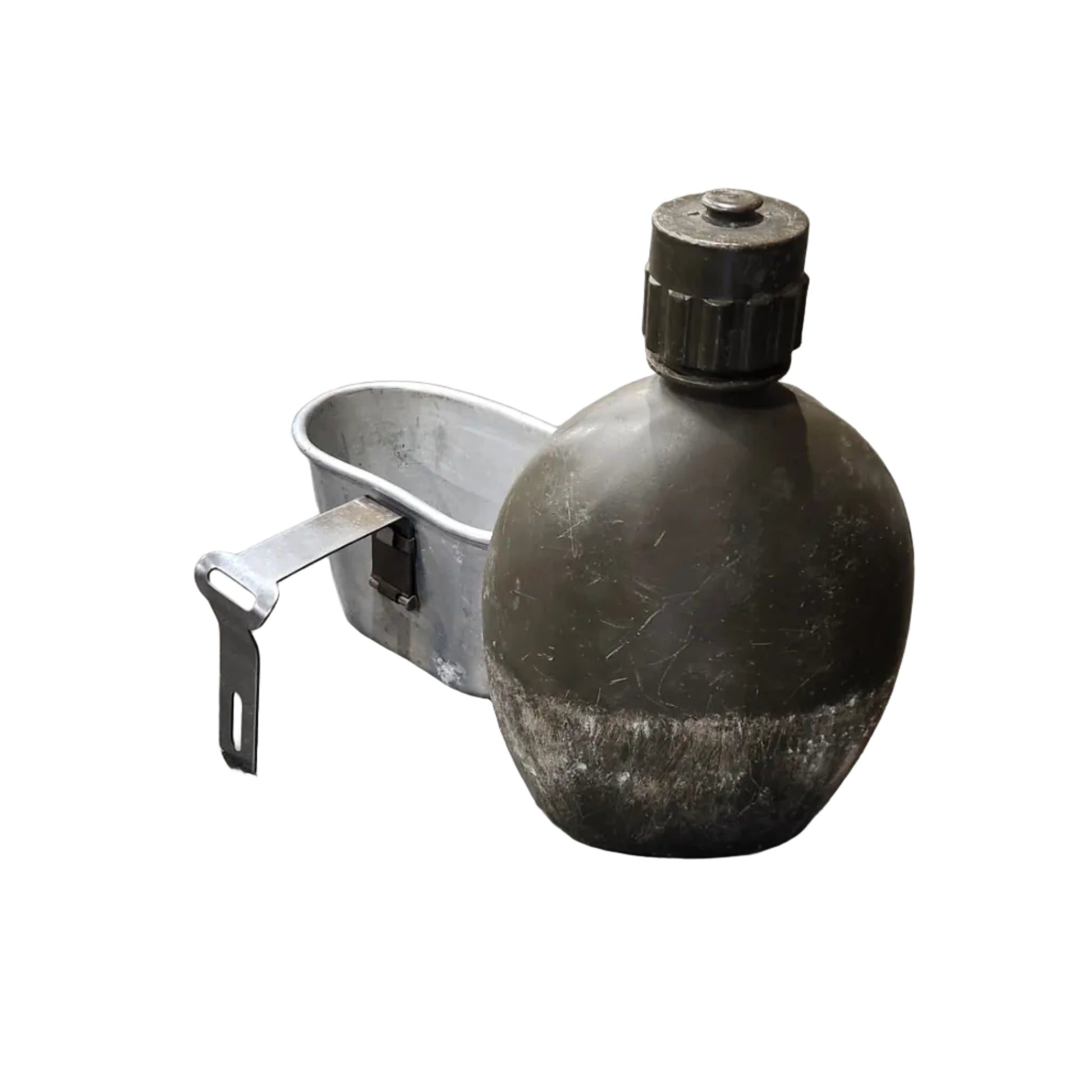 A dark, worn black bottle or container with a white loop handle, resting on a scratched gray concrete floor.