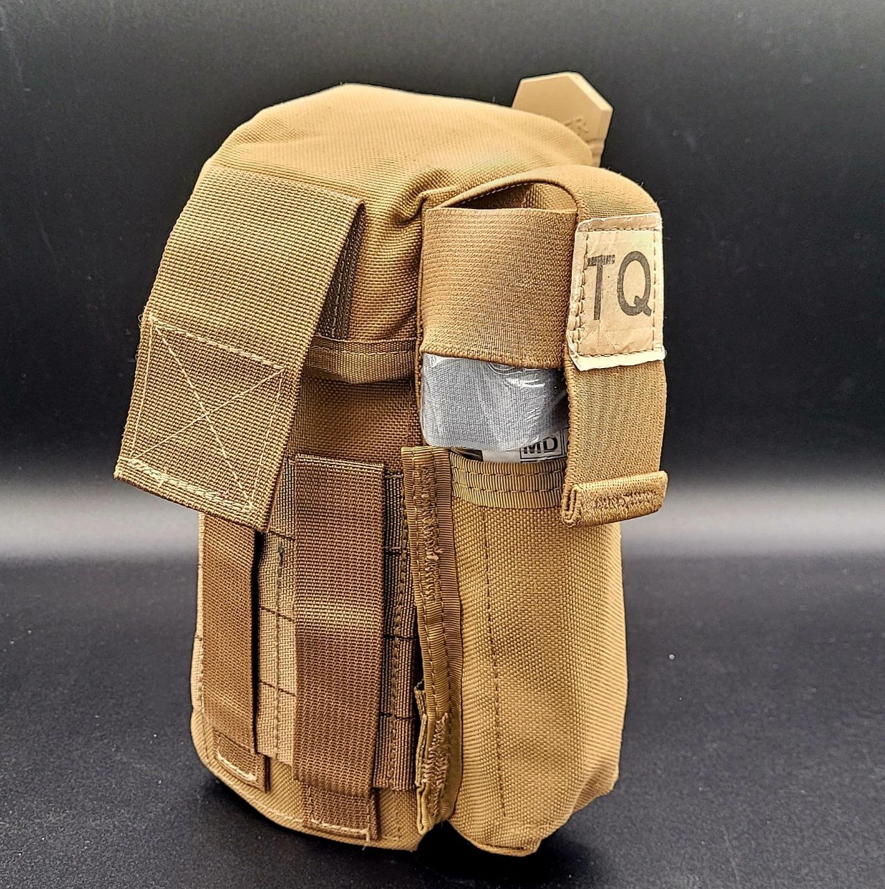 Tan tactical pouch with 'TQ' label on a black background