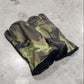 Camouflage-patterned glove on a concrete surface