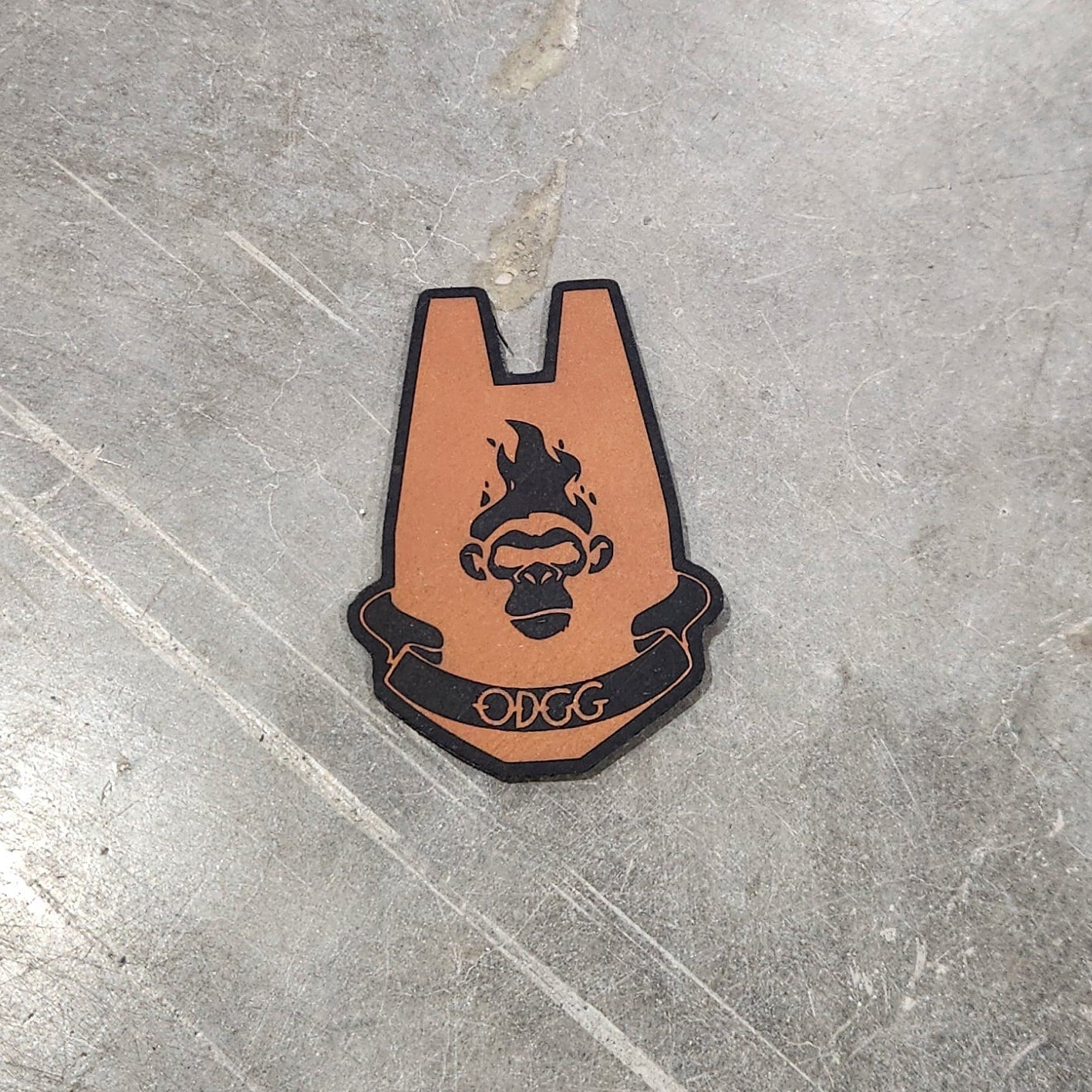 Small leather patch with a design on a gray concrete floor