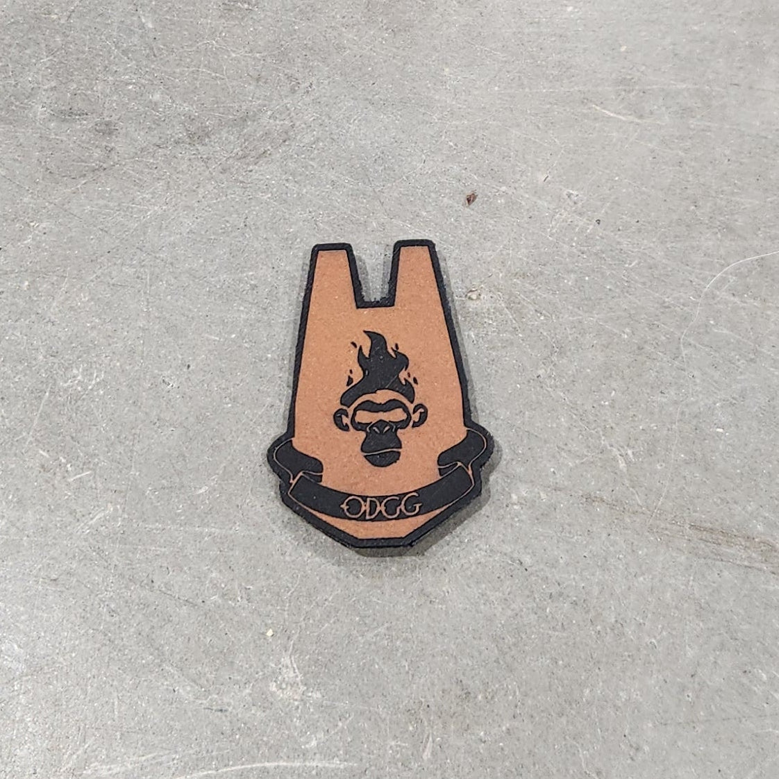 Two small leather patches on a concrete surface