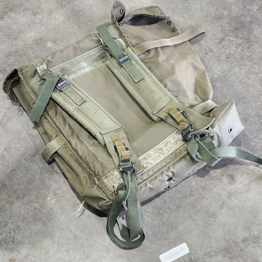 Green backpack on a concrete surface 