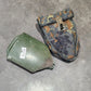 Two military-style pouches on a concrete floor
