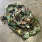 Camouflage fabric and pouches on a concrete surface