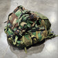 Camouflage backpack on a concrete floor