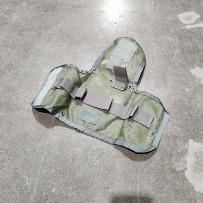 Camouflage-patterned pouch on a concrete floor