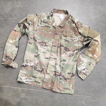 Multicam patterned shirt on a concrete floor with a person wearing similar pants.