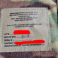 Label on a camouflage vest with text details