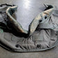 Gray tactical vest with camouflage pattern on a concrete floor