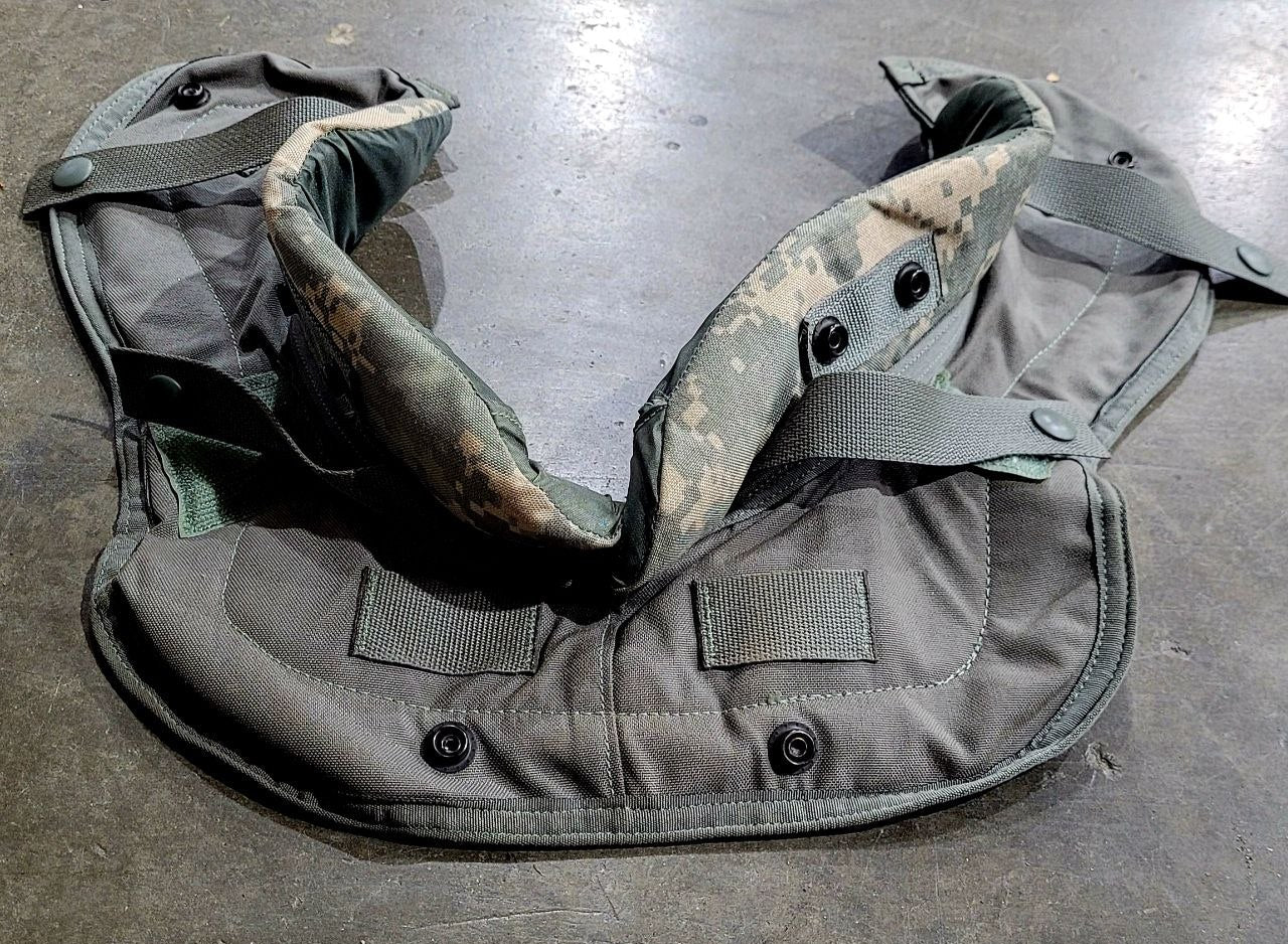 Gray tactical vest with camouflage pattern on a concrete floor
