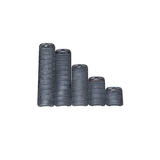 Several black rubber hose or cable rolls arranged on a concrete floor, with a cardboard box on the left and a red-and-black power tool on the right. A person's arm and hand are partially visible in the bottom-right corner, and a photographer's shadow is cast across the scene.