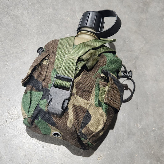 Camouflage-patterned pouch on a concrete surface