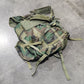 Camouflage backpack on a gray tiled floor