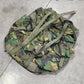 Camouflage backpack on a concrete floor