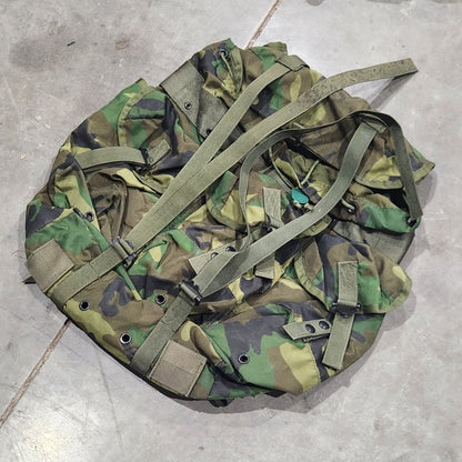 Camouflage backpack on a concrete floor