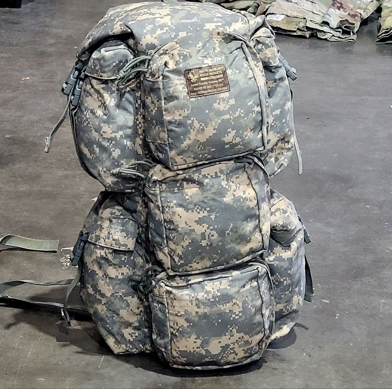Camouflage backpack on a dark surface