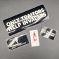 Close-up of a car's interior with 'Only Travellers' and 'O'ellly' stickers on a black surface.