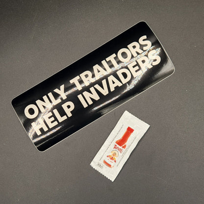 Two stickers on a dark surface, one black and white, the other red and white.