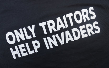 Black t-shirt with white text 'ONLY TRAITORS HELP INVADERS' on a black background