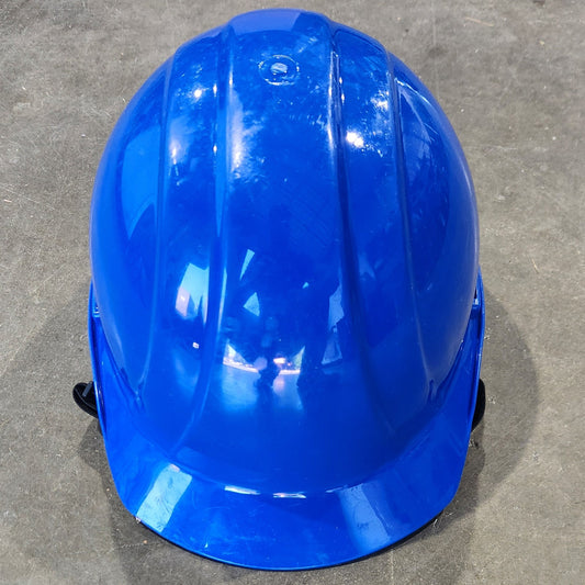 Blue hard hat on a concrete floor