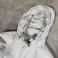 Person wearing a hooded jacket with a textured surface