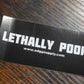 Black card with 'LETHALLY POOR' text on a wooden surface