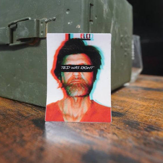 Small album cover on a wooden surface with a green ammunition box in the background