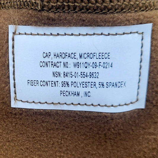 Label on a brown microfleece garment with text details.