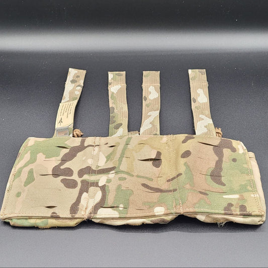 Camouflage tactical vest with multiple straps on a gray background