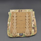 Camouflage tactical magazine pouch with a tan interior panel on a gray background