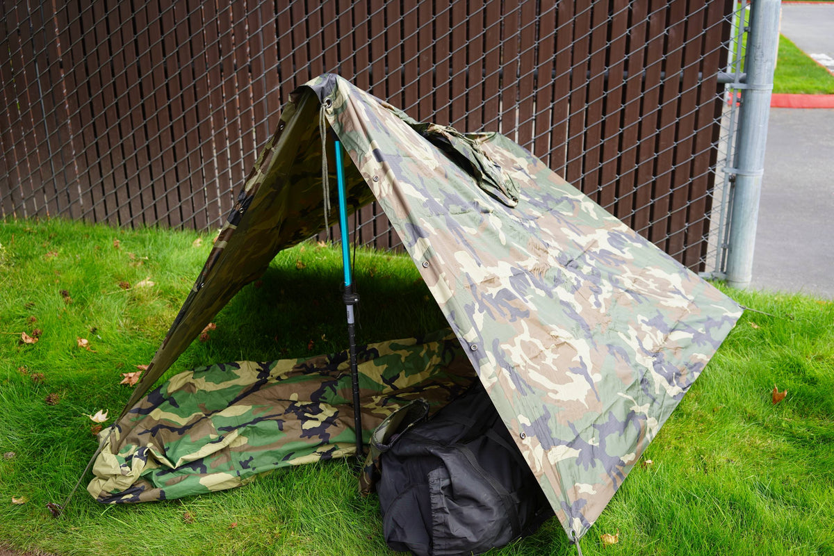 a poncho propped up with trekking poles for shelter