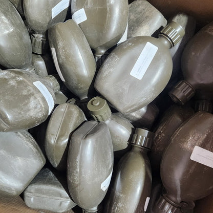 A group of military-style water bottles in olive drab and brown camouflage, packed inside a cardboard box with white labels attached.