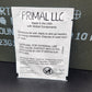 A white paper instruction card with black text and a PRIMAL LLC logo, placed on a dark gray textured surface.