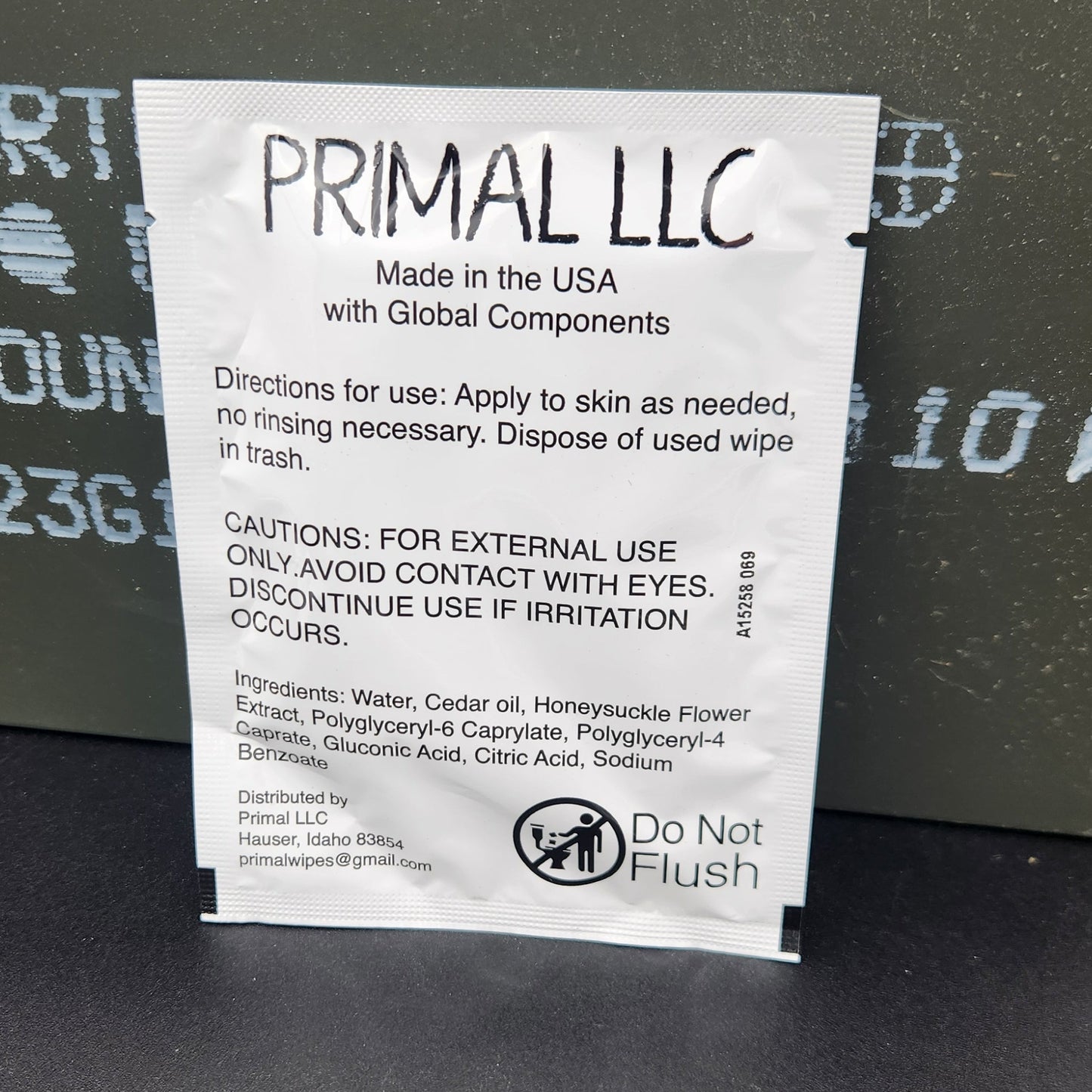 A white paper instruction card with black text and a PRIMAL LLC logo, placed on a dark gray textured surface.