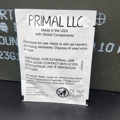 A white paper instruction card with black text and a PRIMAL LLC logo, placed on a dark gray textured surface.