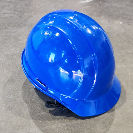 Blue hard hat on a concrete floor