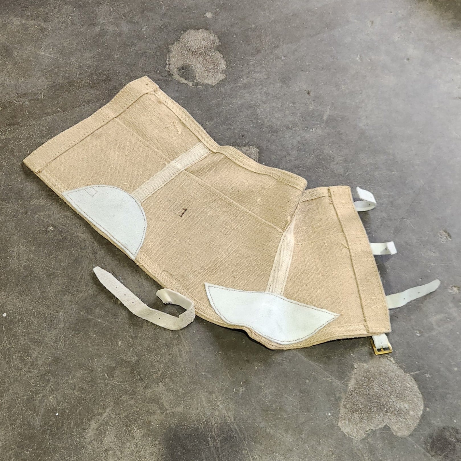 Small pouch with white accents on a textured surface