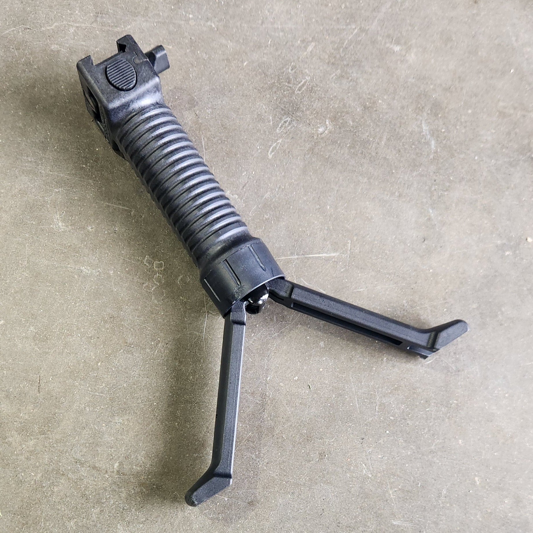 Black gun cleaning tool on a concrete surface