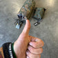 Hand giving a thumbs up with camouflage bags on a concrete floor