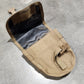 Tan tactical pouch on a concrete floor