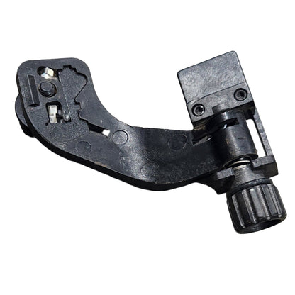 Black metal lever or handle on a gray surface