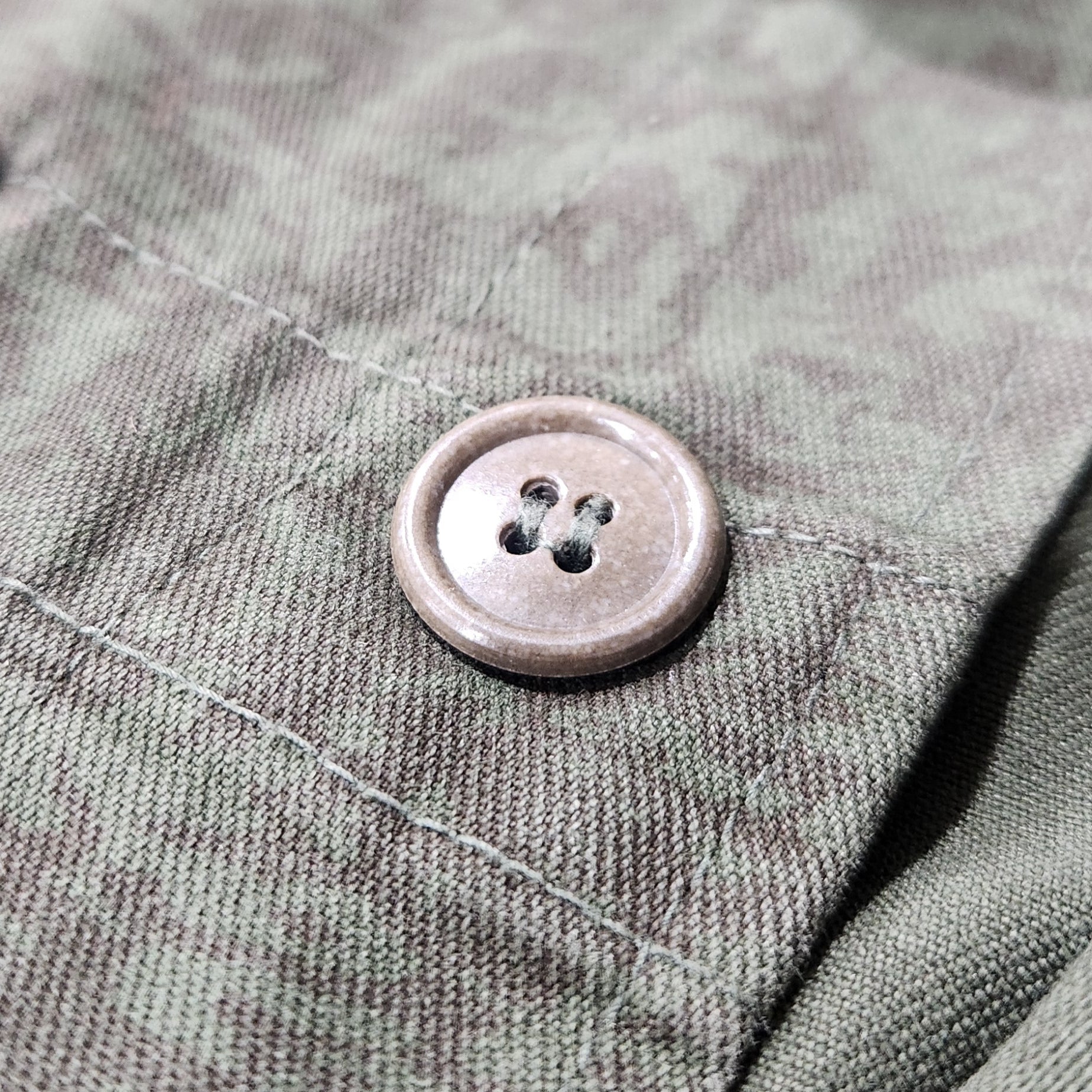 Close-up of a button on a textured fabric surface