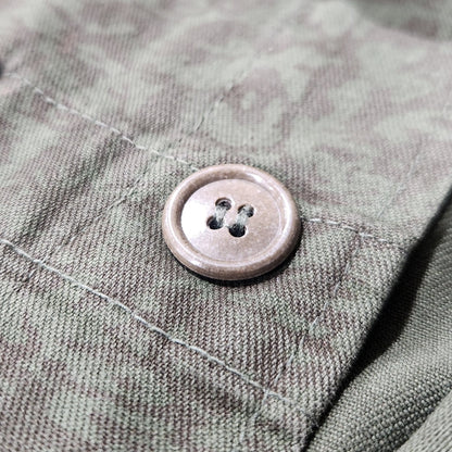 Close-up of a button on a textured fabric surface
