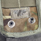 Camouflage pouch with metal grommets on a textured surface