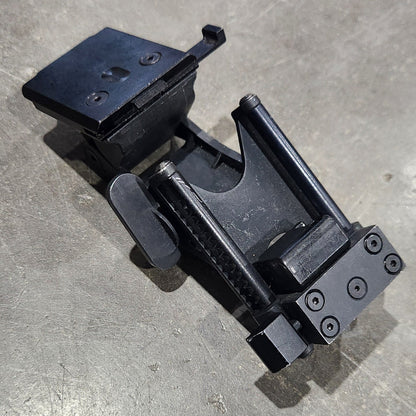 Black metal clamp on a gray concrete surface