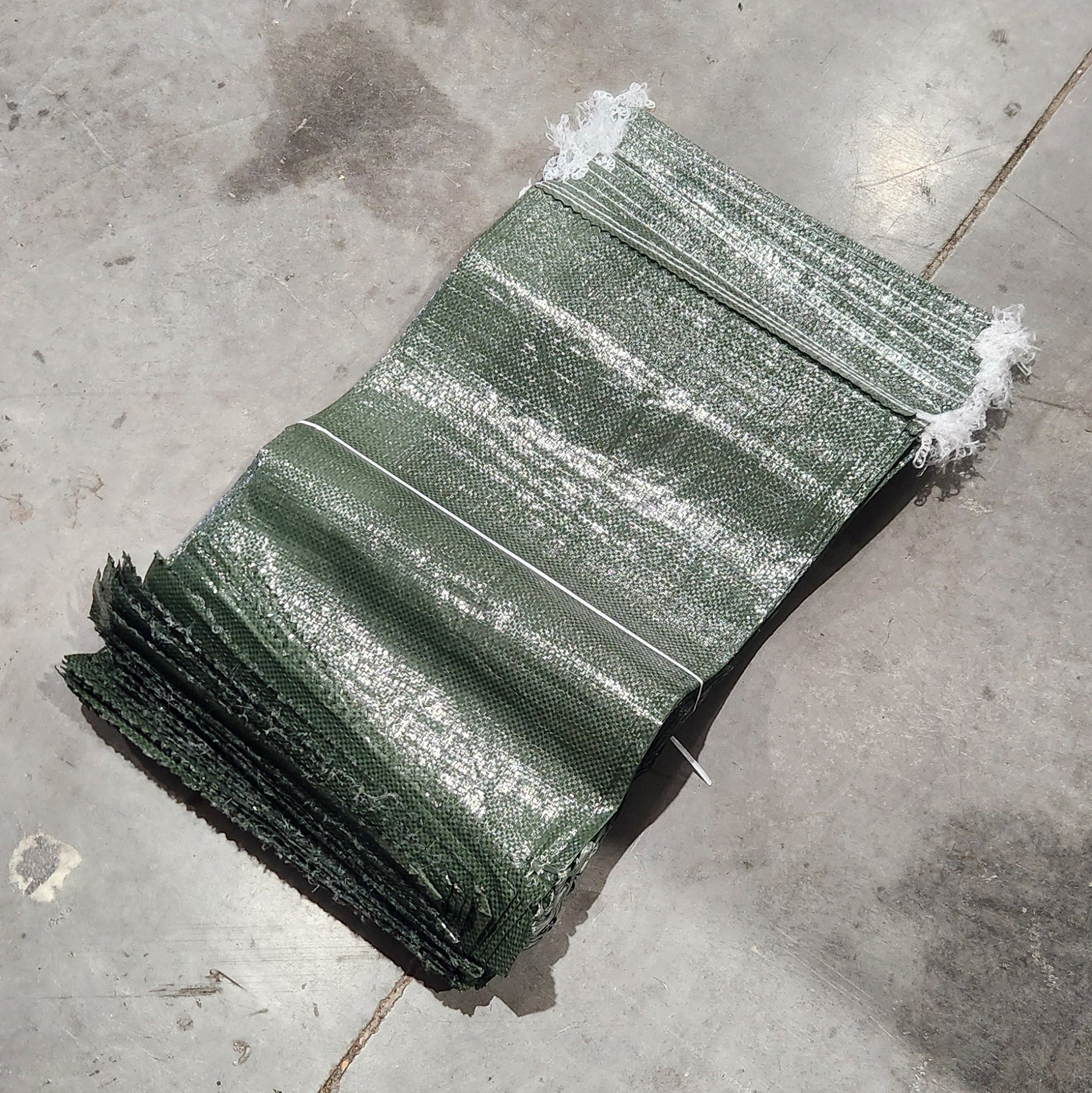 Green plastic sheet on a concrete floor