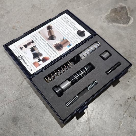 Tool kit with various components on a concrete floor