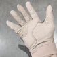 Beige glove on a dark surface