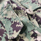 Close-up of a camouflage military uniform with visible branding.