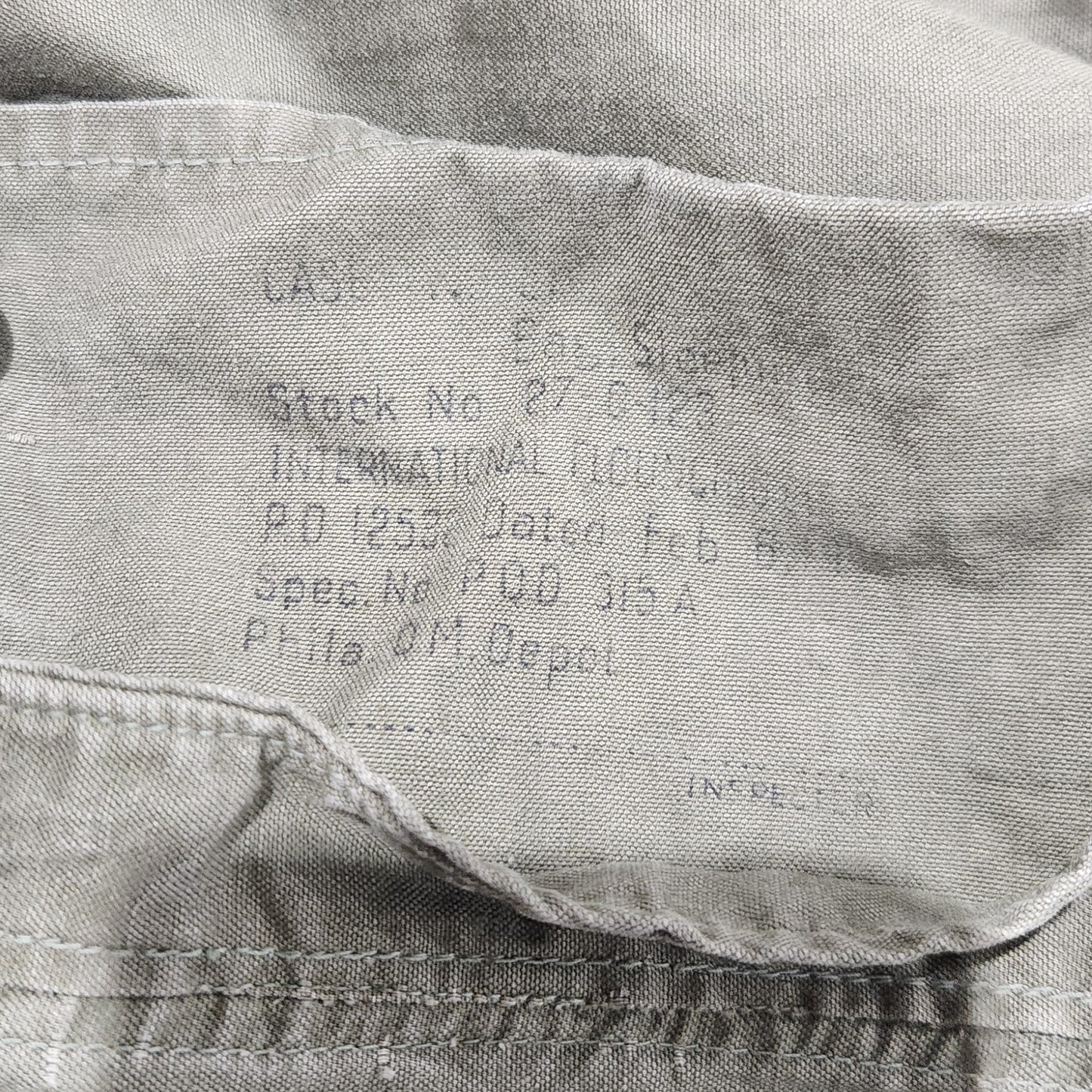 Close-up of a shirt with text on the collar